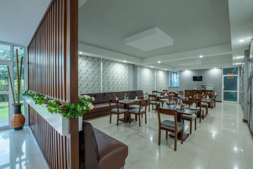 Caran Hotel Kampala restaurant or dining area with view of part frontdesk area