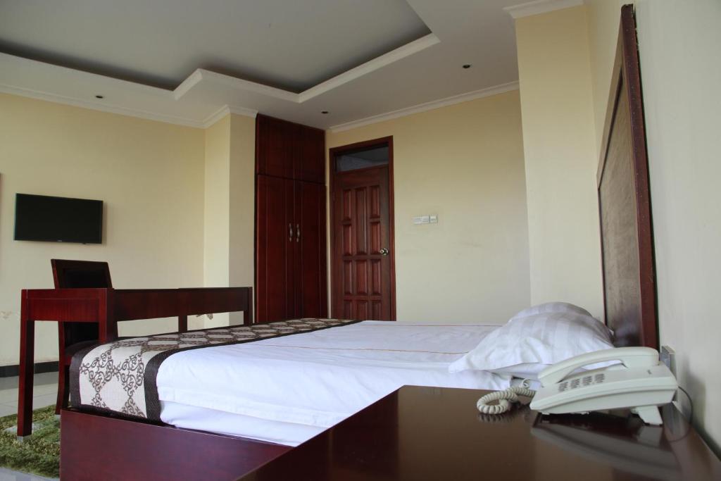 Deluxe Single Bed photo Showing the working desk and telecom Namayiba Park Hotel Kampala Uganda Central Region