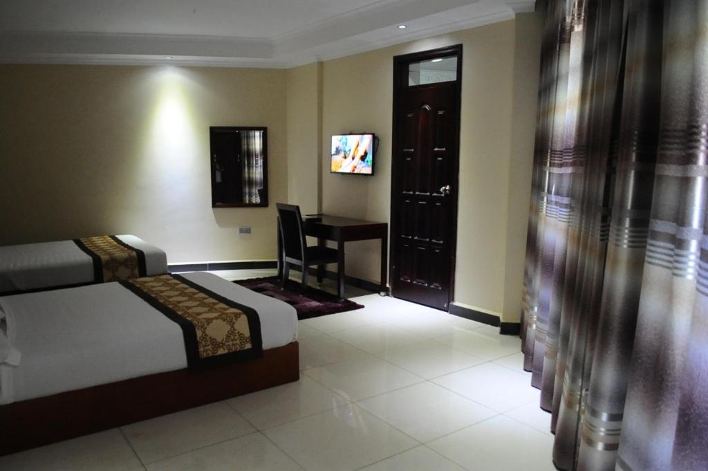 Deluxe Double Twin Bedroom photo showing room Amenities Namayiba Park Hotel Kampala Uganda Central Region