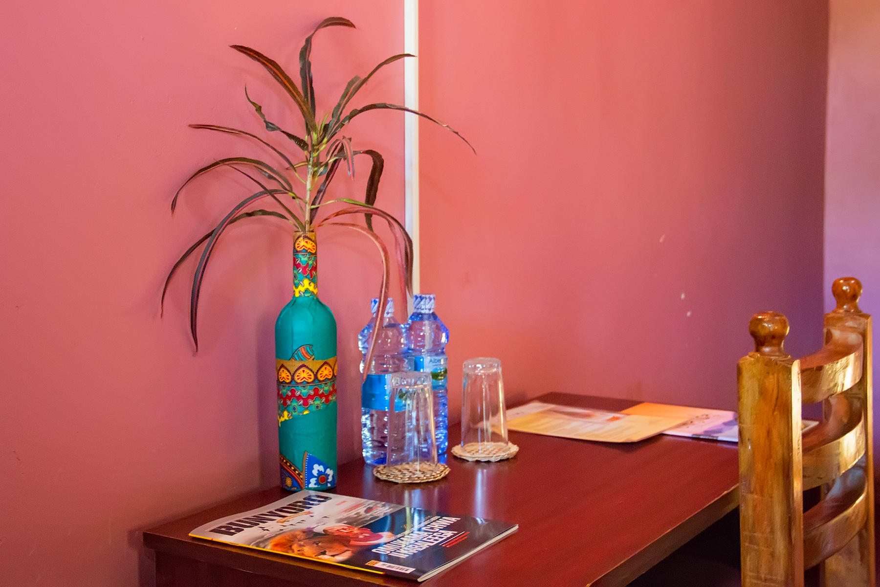 Working Desk in the Bedroom with a bottle of water Photo Hoima Cultural Lodge Hoima Uganda Western Region