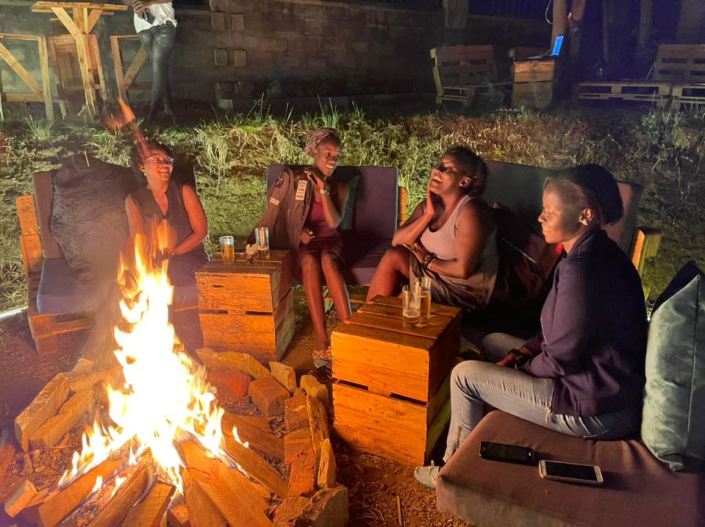 Fireplace area with people having fun photo Ikon Boutique Hotel Garuga, Entebbe Uganda Central Region