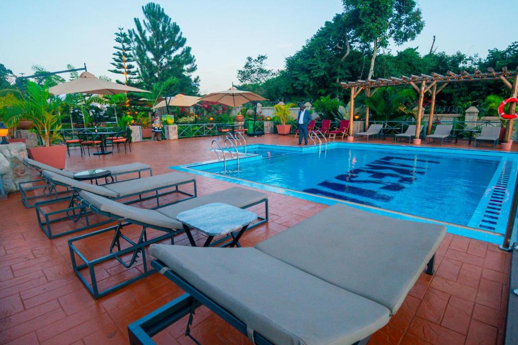 Outdoor swimming pool chairs Photo The Lakeside Resort Entebbe Uganda Central Region