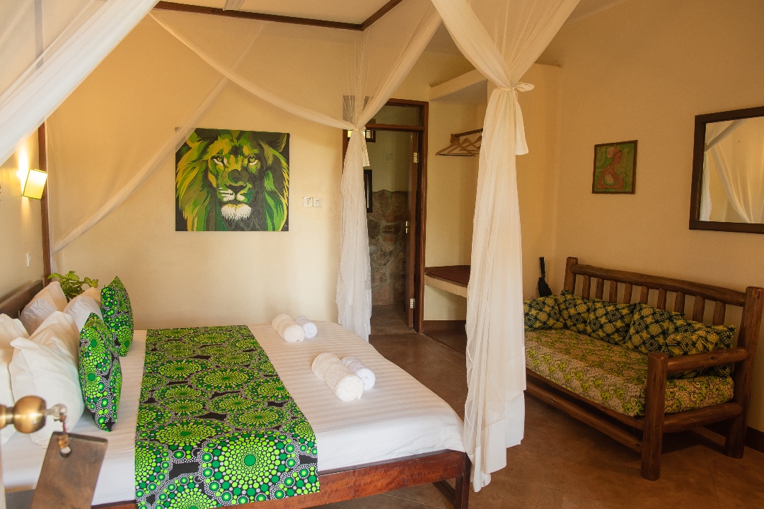 Standard Double Bedroom with sitting chair Photo Karibu Guest House Entebbe - Guest Houses | Entebbe, Uganda Central Region