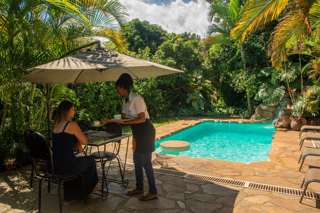 Outdoor Swimming Pool with sitting umbrella Photo Karibu Guest House Entebbe - Guest Houses | Entebbe, Uganda Central Region