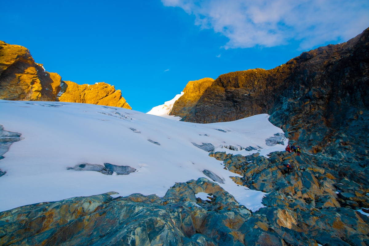 A photograph of the Rwenzori Mountain ranges covered in snow captured during a hiking experience in Rwenzori Mountains National Park in Western Uganda.
