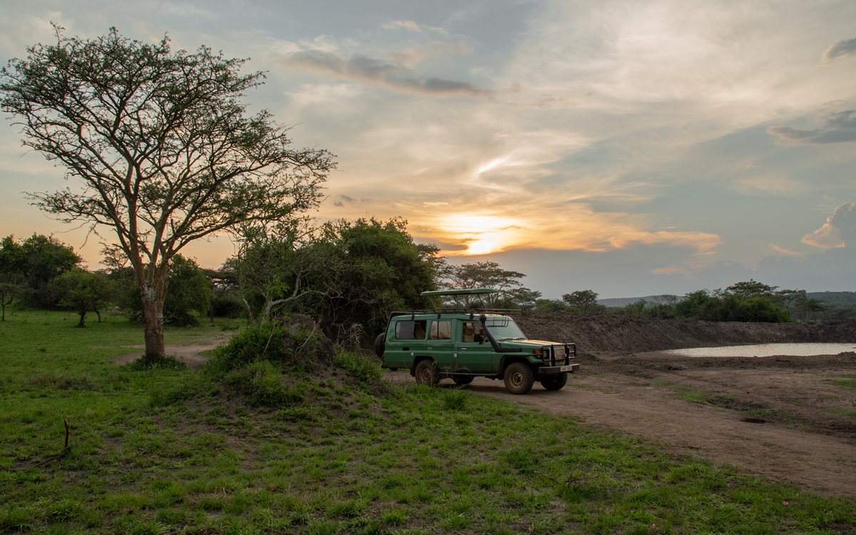 A photograph of a touring vehicle captured during a game drive in Lake Mburo National Park in Nyabushozi County, Kiruhura District in Uganda.