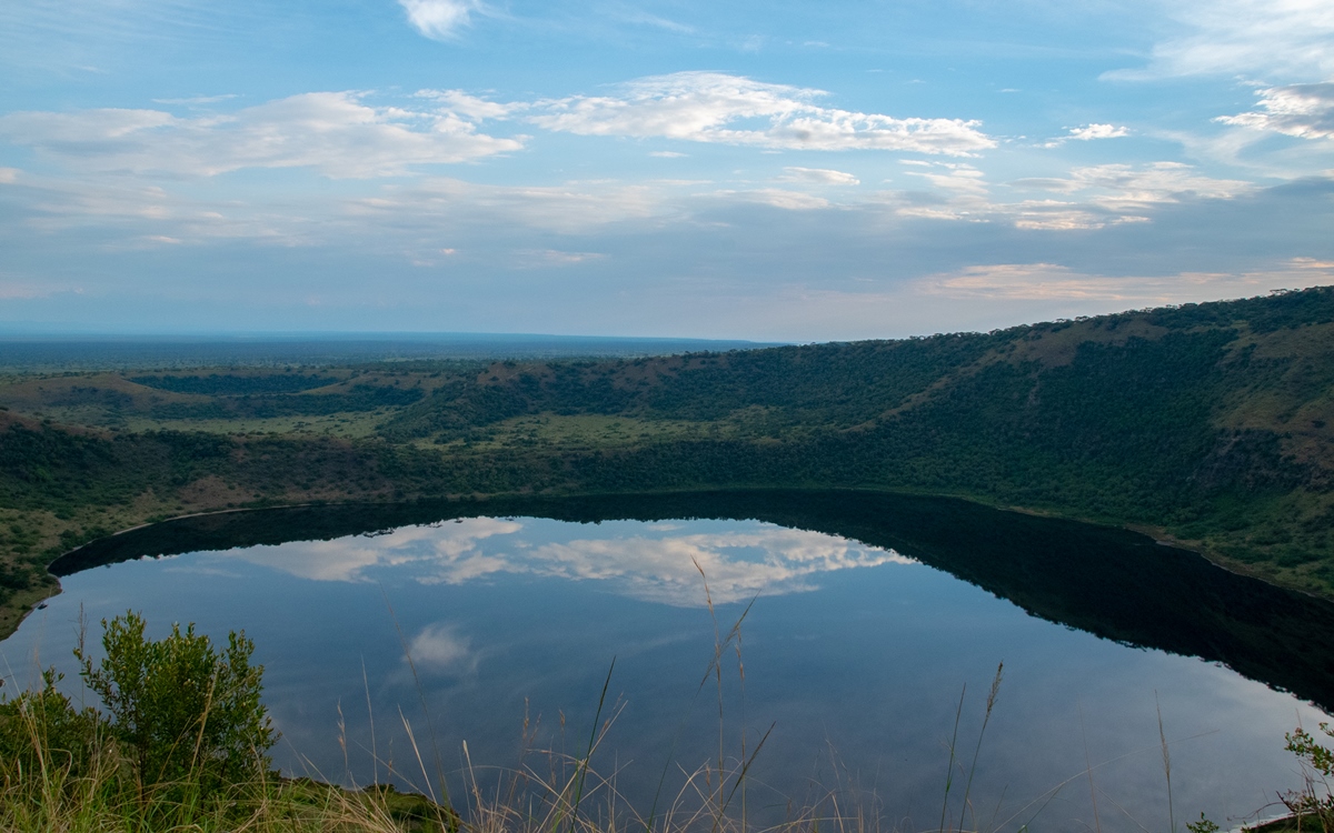 A photograph of a crater lake captured in Queen Elizabeth National Park in the Western Region of Uganda.