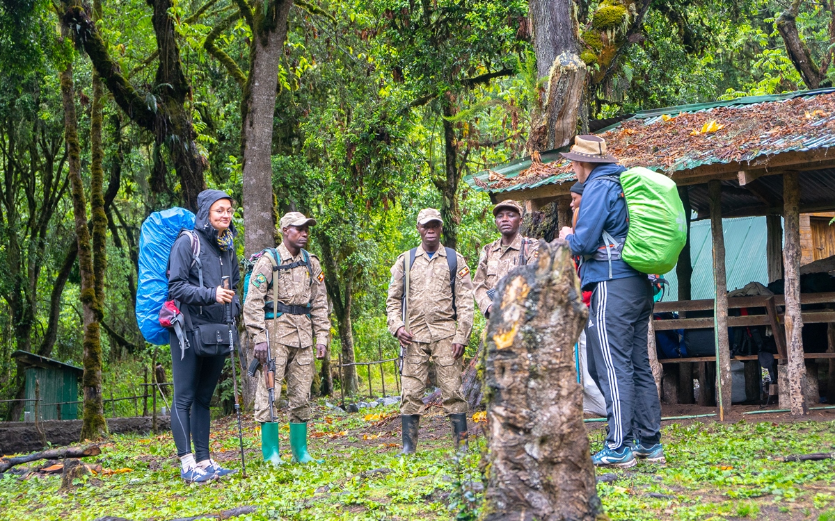 A photogragh of Game rangers and tourists captured in Mount Elgon National Park located both in Uganda and Kenya.
