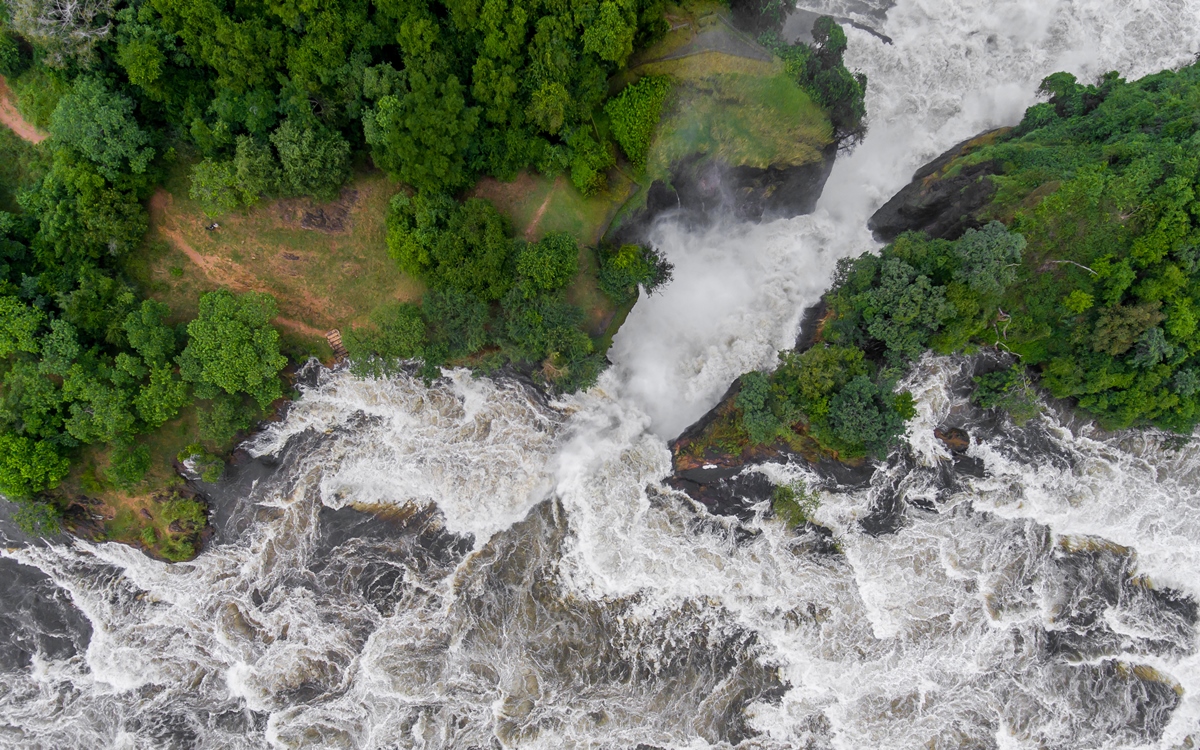 A photograph showing an aerial view of the Murchison Falls captured in Murchison Falls National Park in Northern Uganda.