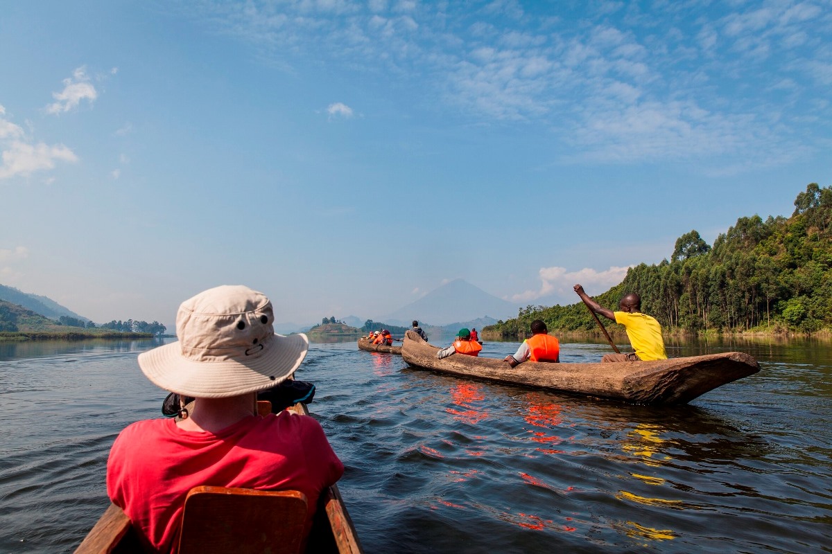 A photograph of tourists and a guide taken during a canoeing tour on Lake Mutanda in Western Uganda.