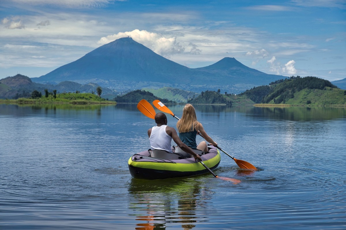 A photograph of a tourist and a guide taken during a canoeing tour on Lake Mutanda in Western Uganda.