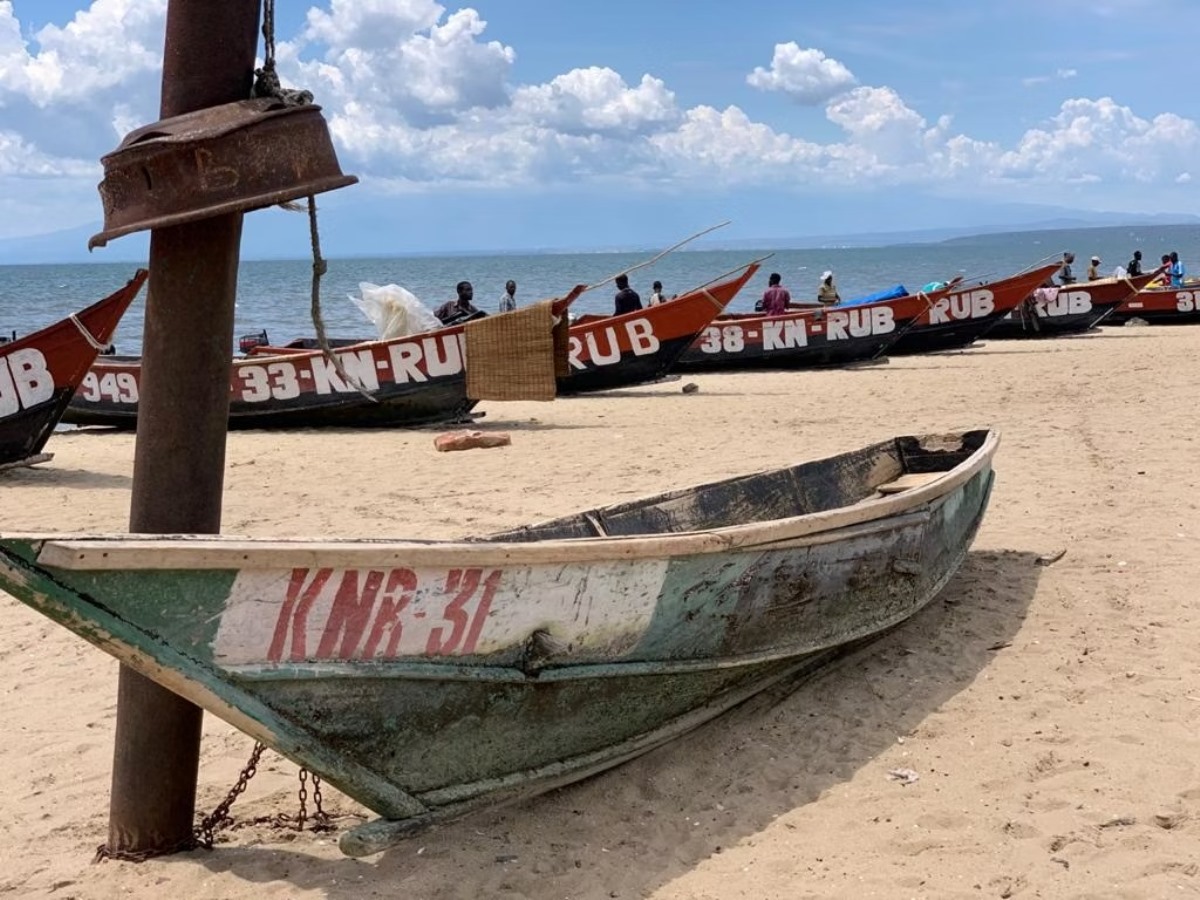 A photograph of fishermen docking their boats on the shores of lake Albert taken during a tour to Lake Edward in the Albertine Rift of Uganda