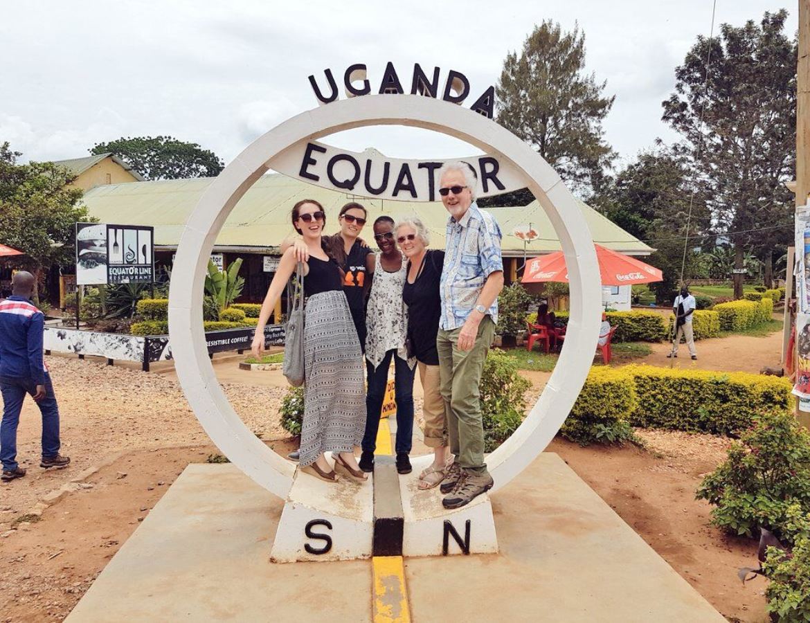 A photograph of tourists at the Uganda Equator in Kayabwe taken during an adventure tour