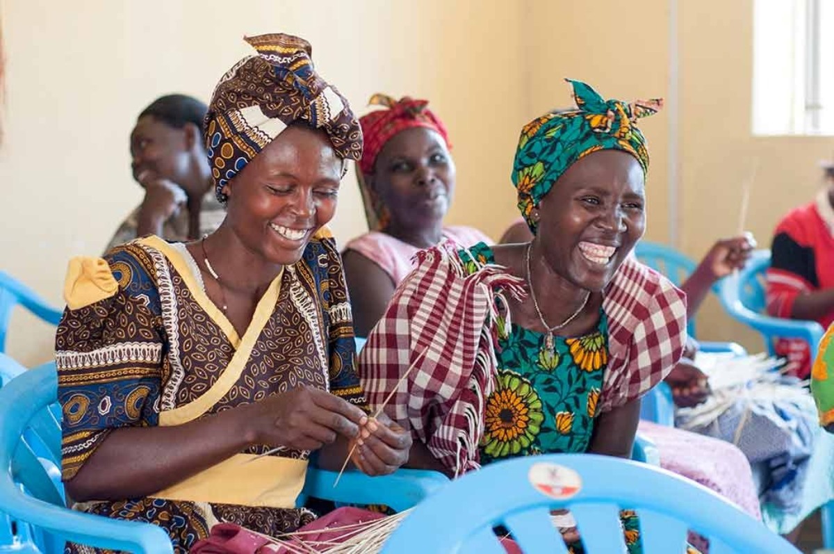 A photograph of women weaving baskets taken during a village tour to Rubona located along Fort Portal–Kasese–Mpondwe Road in Uganda