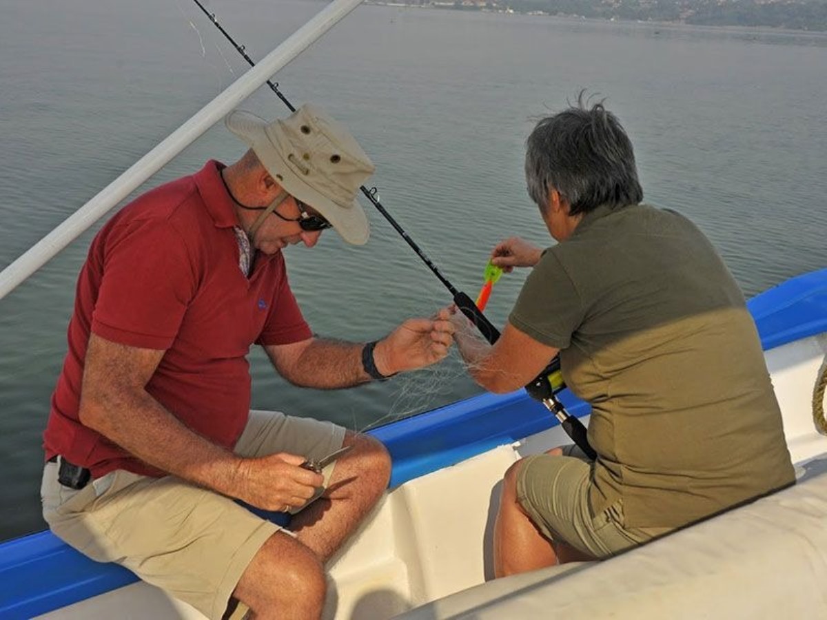 A photograph of tourists fishing taken during a Lake Victoria Fishing trip in Uganda.