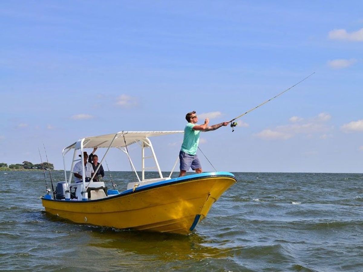 A photograph of tourists fishing taken during a Lake Victoria Fishing trip in Uganda.