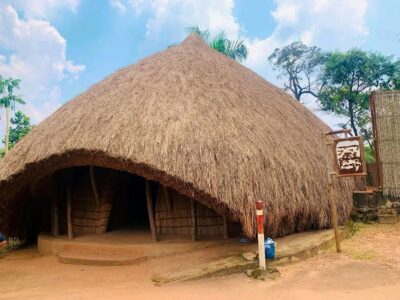 A photograph showing one of the grass-thatched houses taken during a Cultural tour to the Kasubi Tombs in Central Uganda.