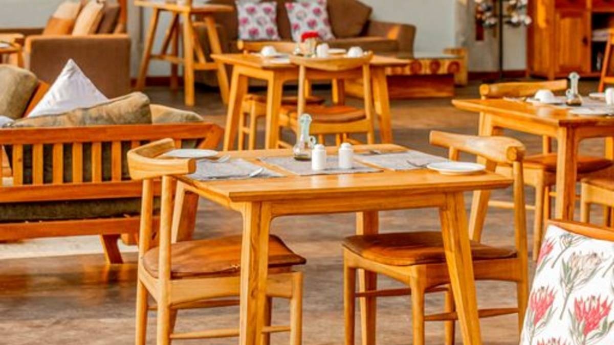 A photograph showing the table setups and sofas at Wildwaters Lodge in Uganda.