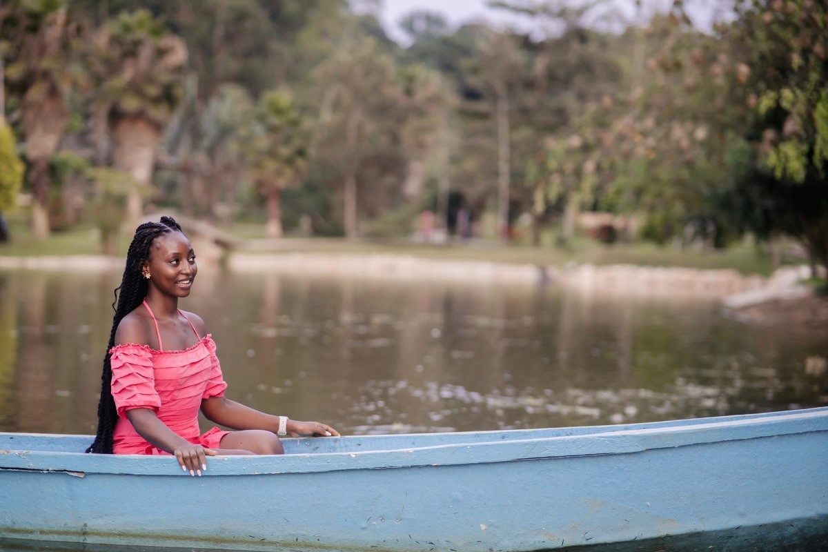 A photograph of a visitor taken during a boat cruise while at Lakes of Grace Farm Resort in Muduuma, Wakiso in Uganda.