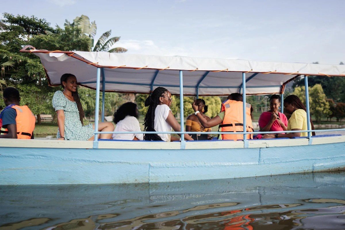 A photograph of visitors taken during a boat cruise while at Lakes of Grace Farm Resort in Muduuma, Wakiso in Uganda.