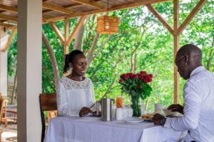 A photograph of a couple having breakfast at Adrift River Club in Jinja in Eastern Uganda.