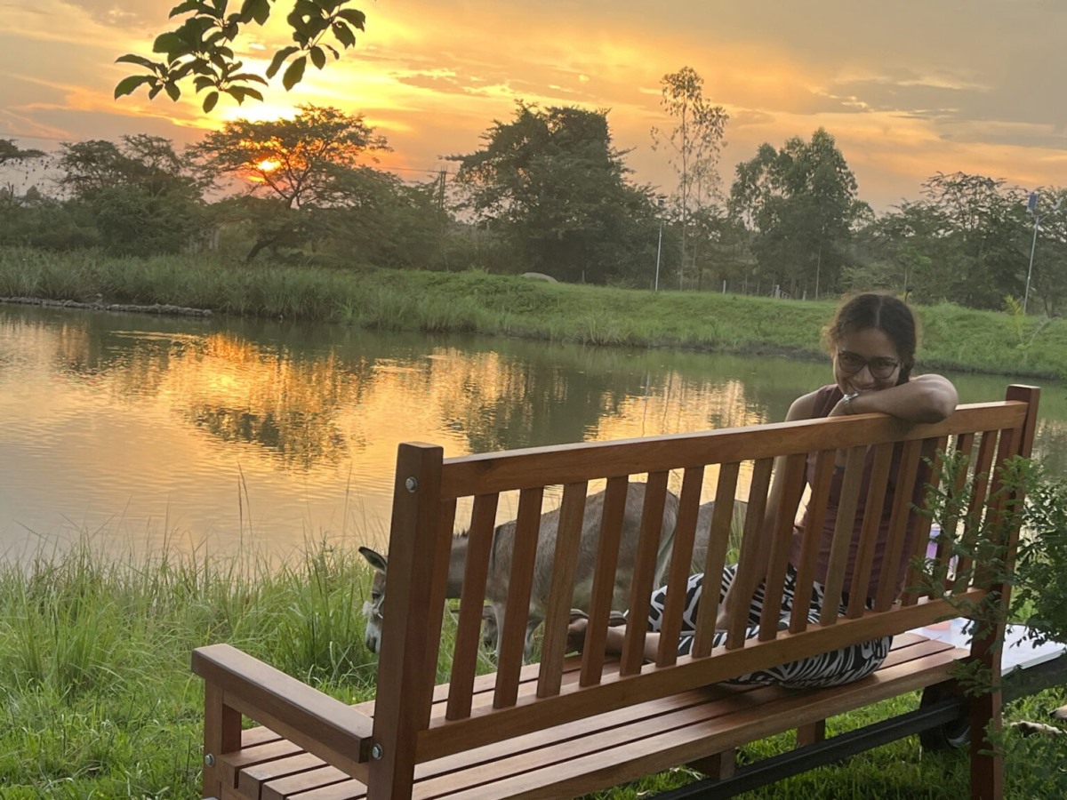 A photograph of a tourist chilling in one of the seats at FARMstay Zirobwe, Uganda.