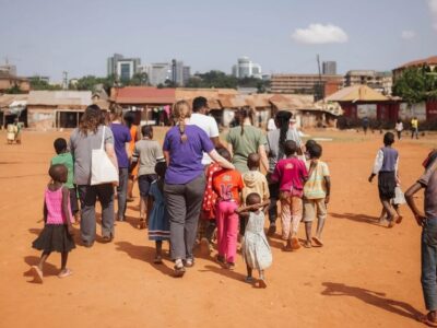 A photograph of tourists and the local kids taken during a village tour in Jinja in Eastern Uganda.