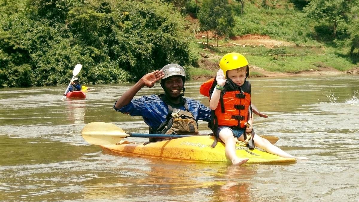 A photograph of a raft guide and a child taken during a family rafting tour in Jinja in Eastern Uganda.