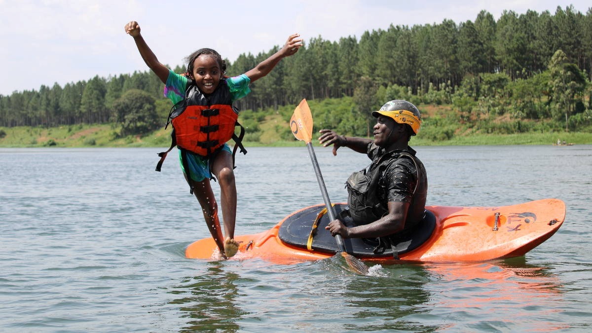 A photograph of a raft guide and a child taken during a family rafting tour in Jinja in Eastern Uganda.