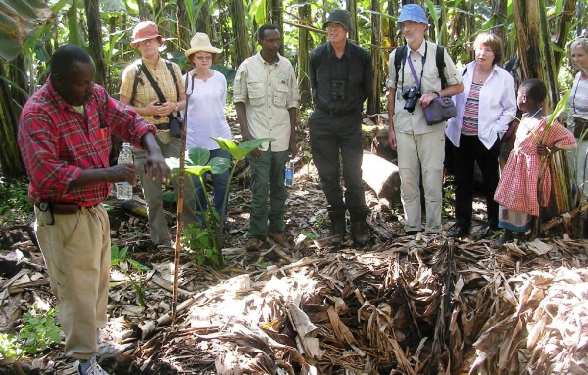 A photograph of tourists and their guide while at the Katereke Prison Ditch in Nsangi in Uganda