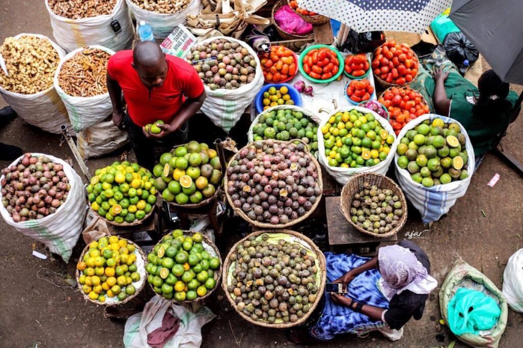 Photograph of market vendors selling fruits taken during afruit market day in Kampala, Uganda