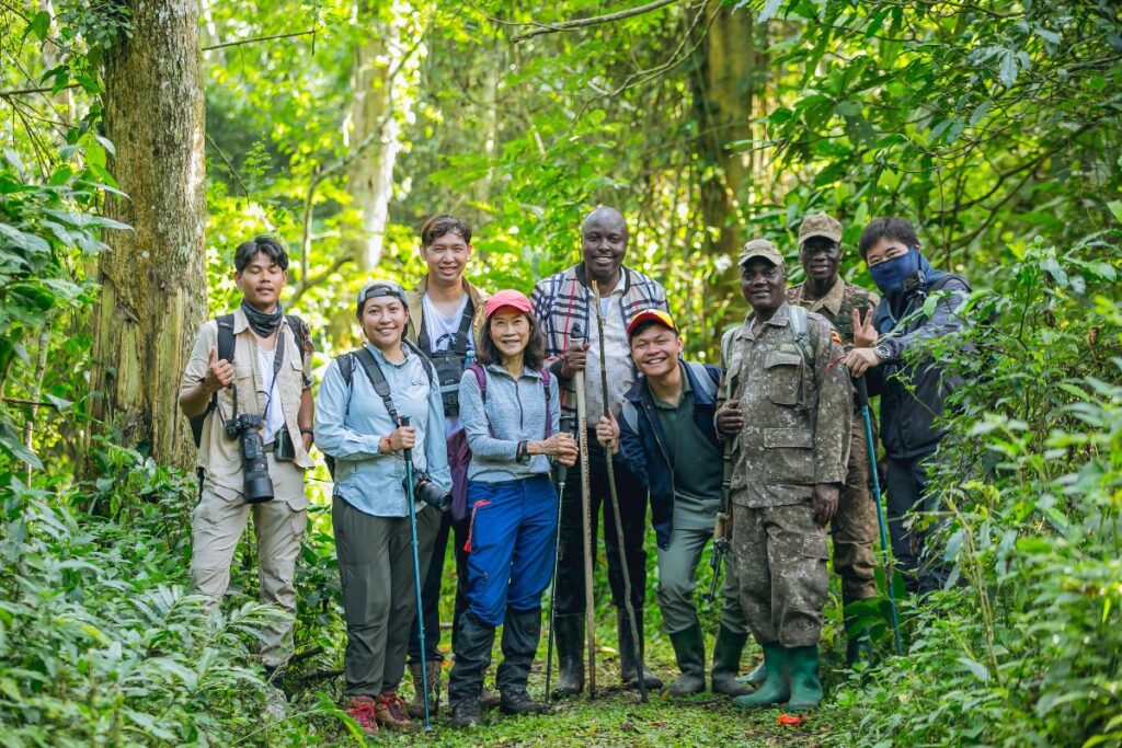 A photograph of the tour operators from the Association of Southeast Asian Nations with their ranger guides taken during their tour in Uganda