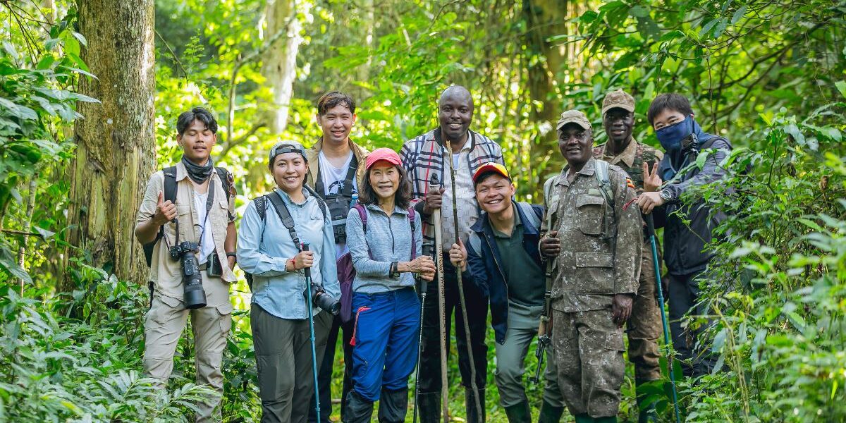 A photograph of the tour operators from the Association of Southeast Asian Nations with their ranger guides taken during their tour in Uganda