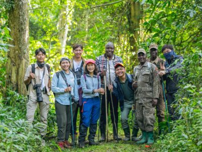 A photograph of the tour operators from the Association of Southeast Asian Nations with their ranger guides taken during their tour in Uganda