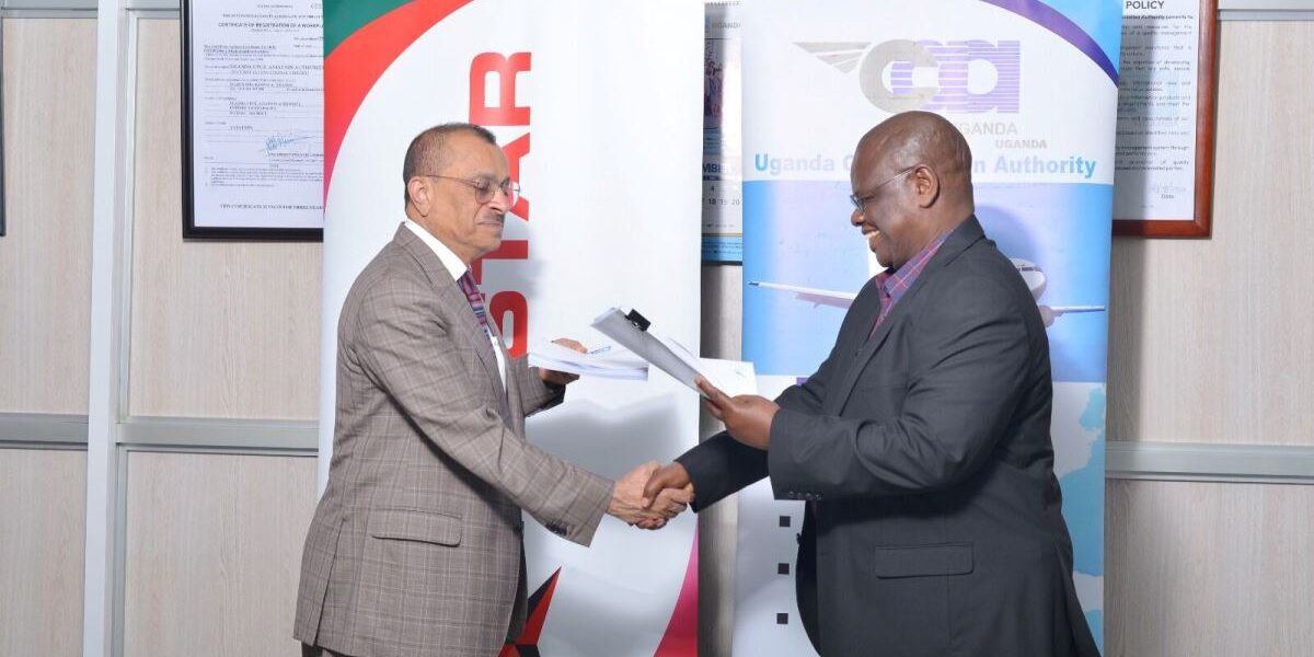 Photograph of the Director General of UCAA, Mr. Fred Bamwesigye shaking hands with the Group Chief Executive of Tristar, Mr. Eugene Mayne