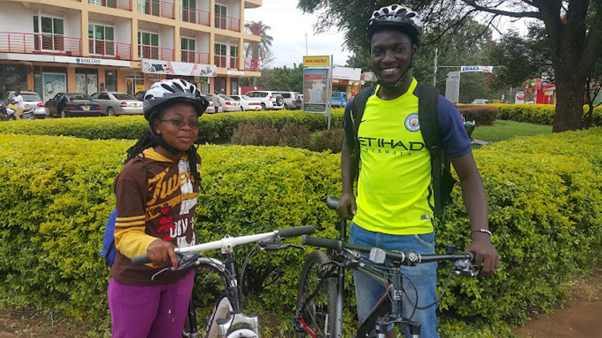 Photograph of a guide and tourist taken during a biking tour in Entebbe, Uganda