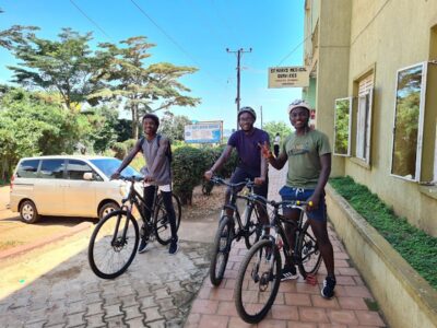 Photograph of three cyclists taken during a biking tour in Entebbe, Uganda