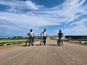 Photograph of three cyclists taken during a biking tour in Entebbe, Uganda