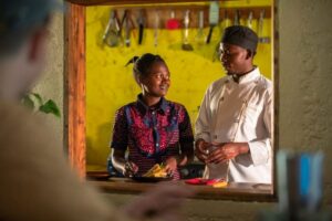 Photograph of a chef and waitress taken from Bwindi Lodge Bar in Western Uganda