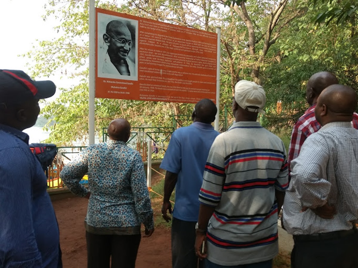 Photograph of tourists reading about the history of Mahatma Gandhi