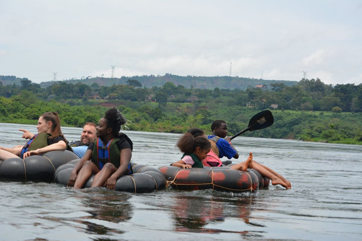 Photograph of tourists and their guide taken during a water tubing tour in Jinja, Eastern Uganda