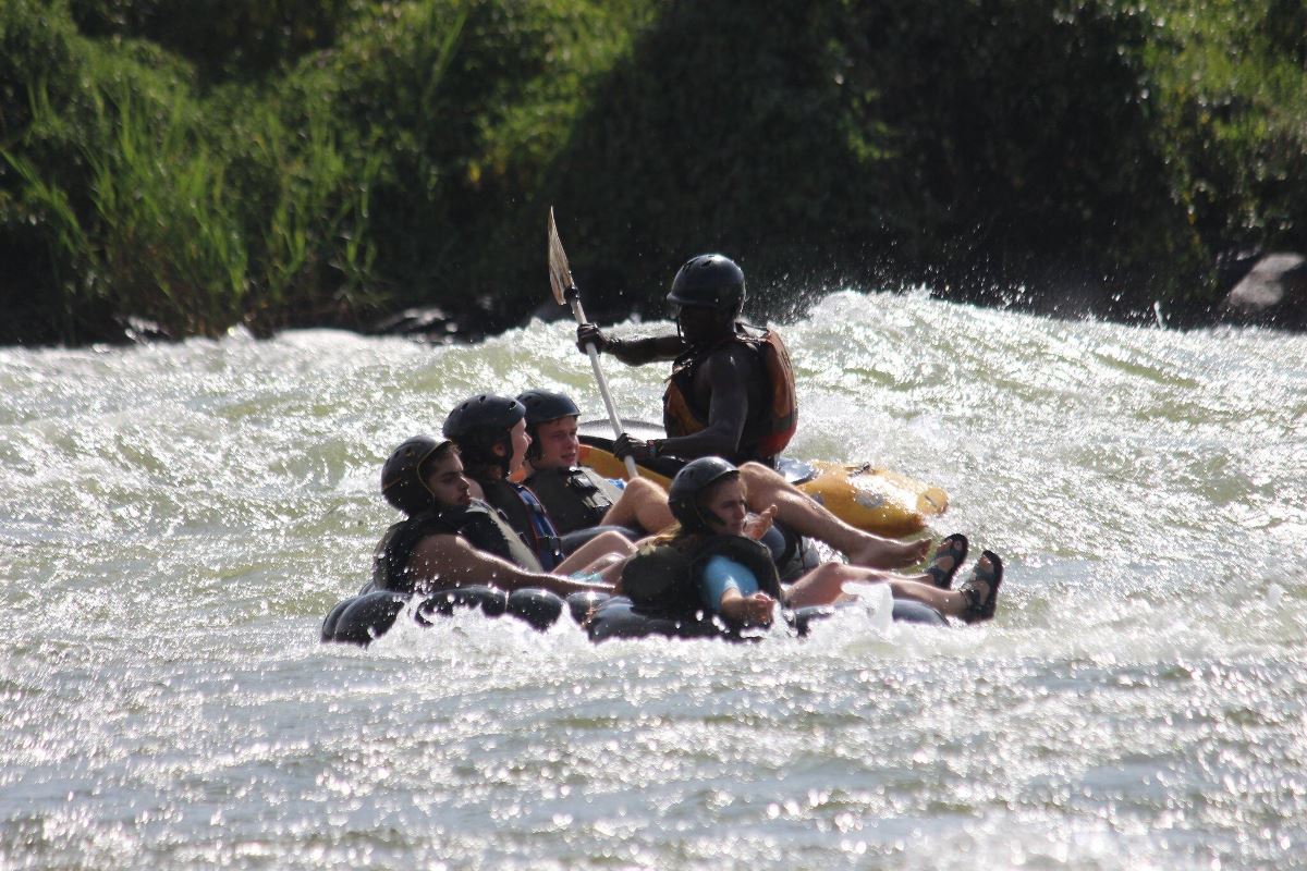 Photograph of tourists and their guide taken during a water tubing tour in Jinja, Eastern Uganda