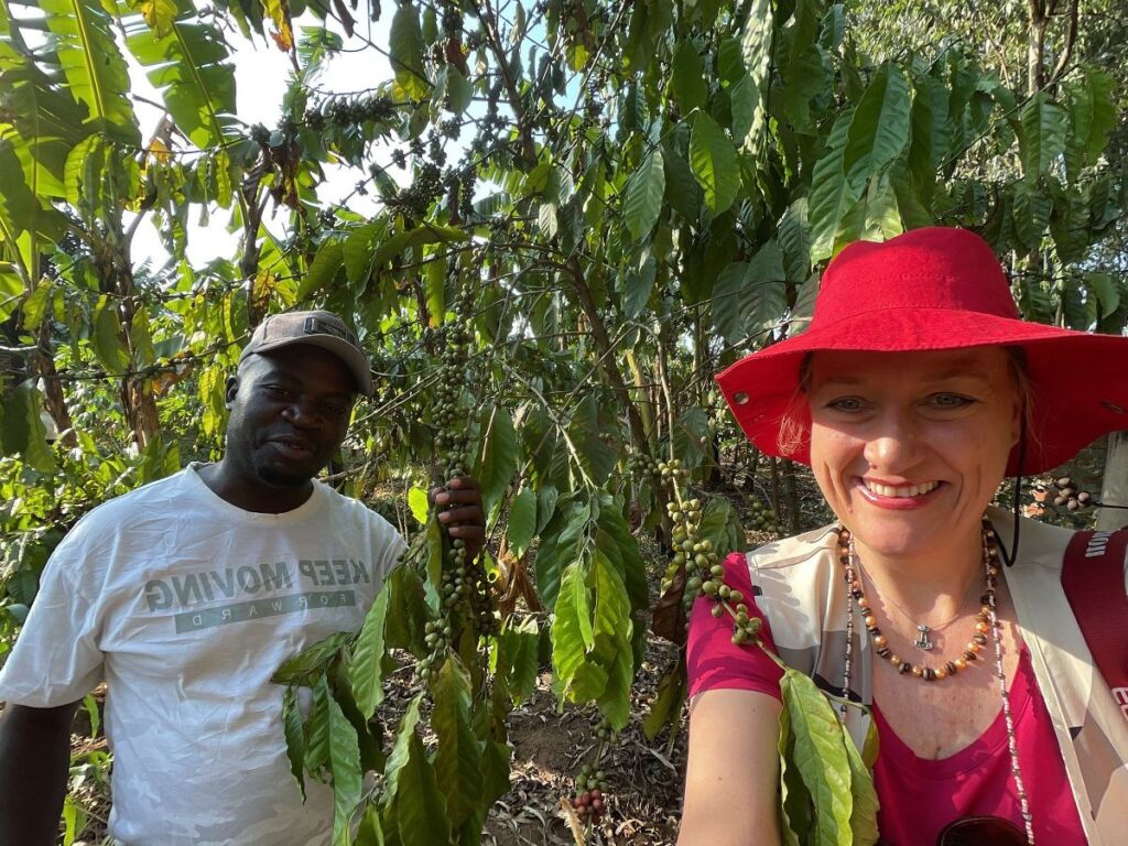 Photograph of a tourist and her guide taken during a coffee farm tour in Uganda