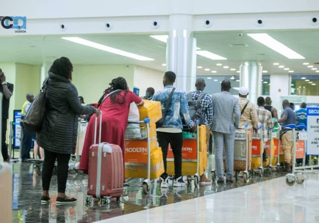 Photograph of passengers in line at a check-in point at Entebbe International Airport in Uganda