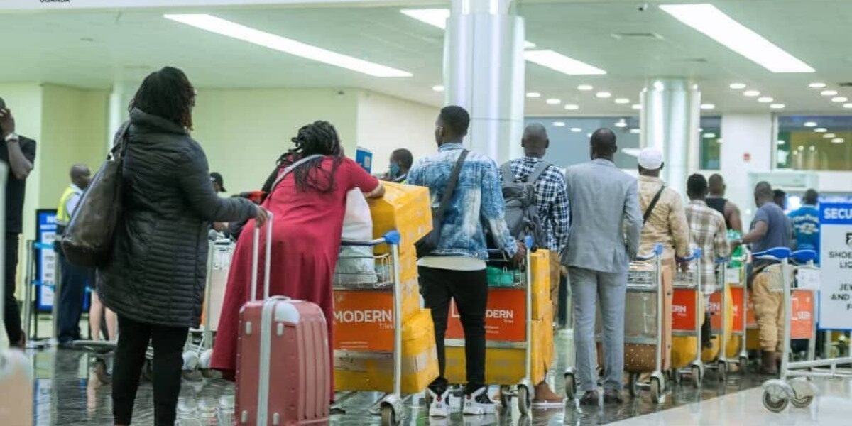 Photograph of passengers in line at a check-in point at Entebbe International Airport in Uganda