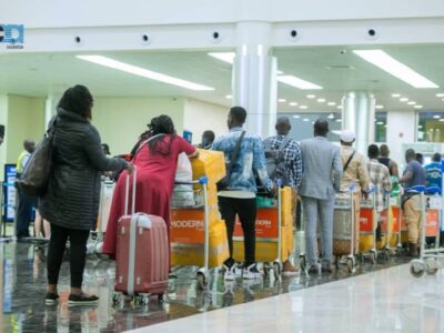 Photograph of passengers in line at a check-in point at Entebbe International Airport in Uganda