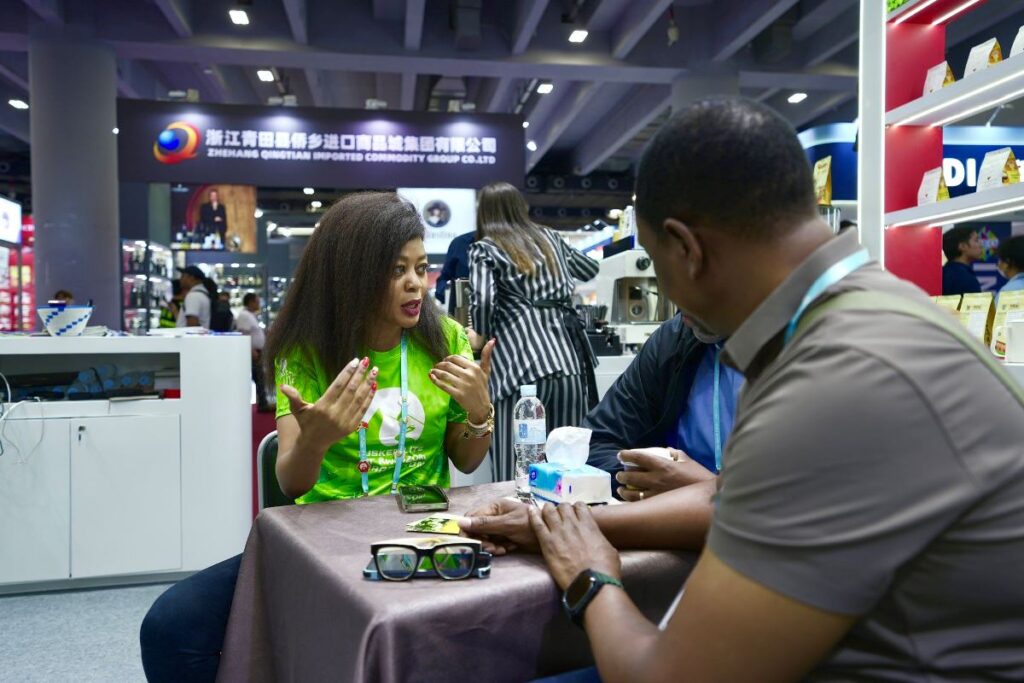 Photograph of Amb. Judyth Nsababera discussing with some of the Ugandan participants taken during the 137th session of the Canton Fair in Guangzhou, China