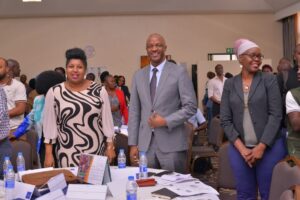 Photograph of the PSFU Board Vice Chairperson Sarah Kagingo, posing PSST Ramathan Ggoobi and Shirley Kongai PSFU Board member for the Real Estate Sector taken during the PSFU National Post-Budget Dialogue