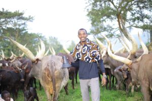 Photograph of a visitor taken at the Nshenyi cultural village in Ntungamo, Western Uganda during the milking experience