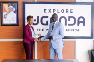 Photograph of Ms. Juliana Kagwa, the new Chief Executive Officer of Uganda Tourism Board shaking hands with Deputy CEO Mr. Bradford Ochieng during the handover ceremony